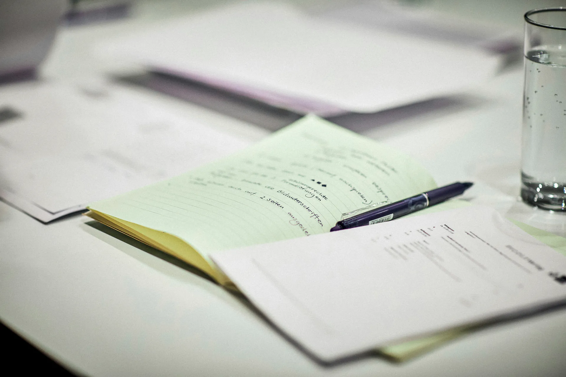 Notebook and documents on table at planning meeting on approval procedure