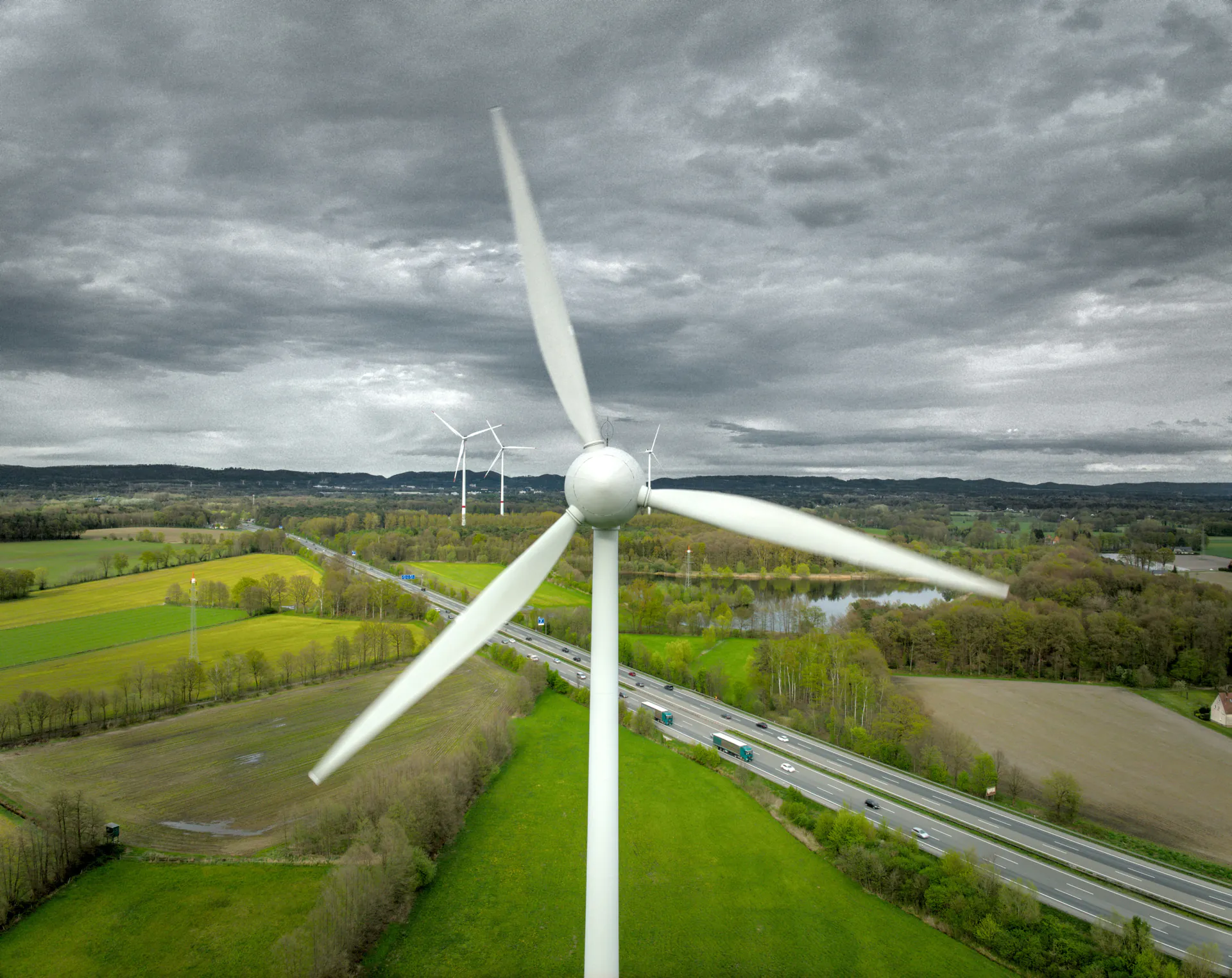 Large wind turbine with road and infrastructure in a rural setting